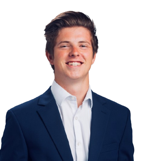 A person in a suit smiling against a plain white background.